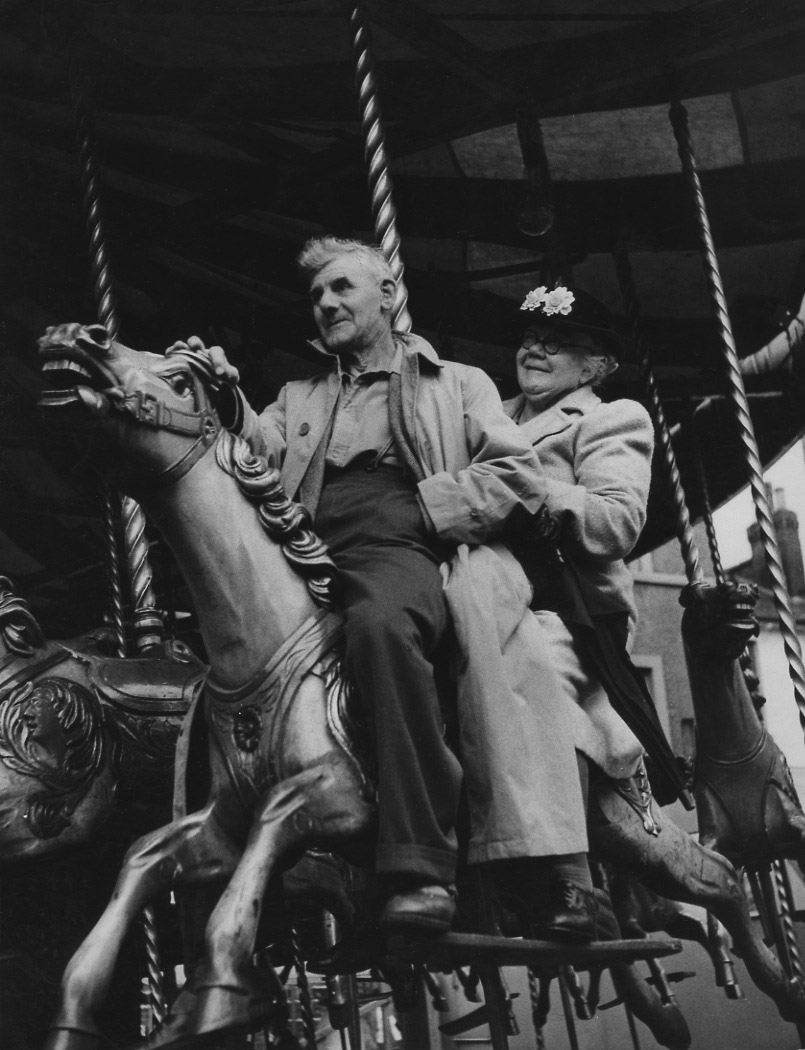 A Couple on Carousel during August Bank Holiday Fair, London