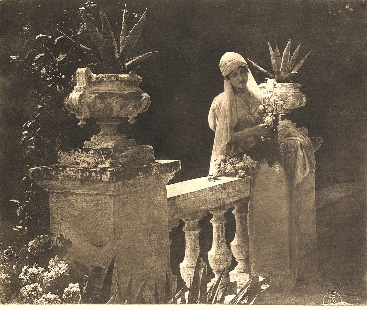 Constant Emile Puyo - Woman with a Bouquet of Flowers on a Staircase