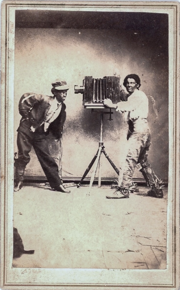 J. D. Vallade - Black Face Performer Operating Large Studio Camera, While Photographing Another Performer in Black Face