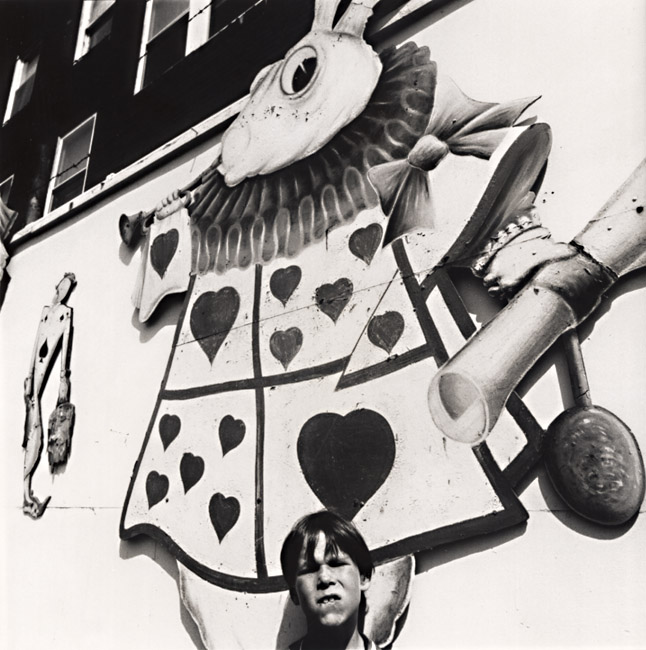 Arthur Tress - Boy with Picture of Alice's Rabbit in Rockaway Playland, Queens, NY